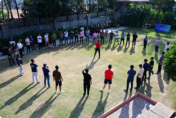 Participants forming a circle for an outdoor team activity