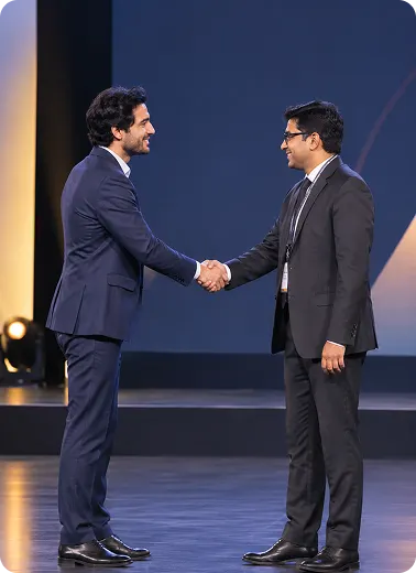 Two professionals shaking hands on stage